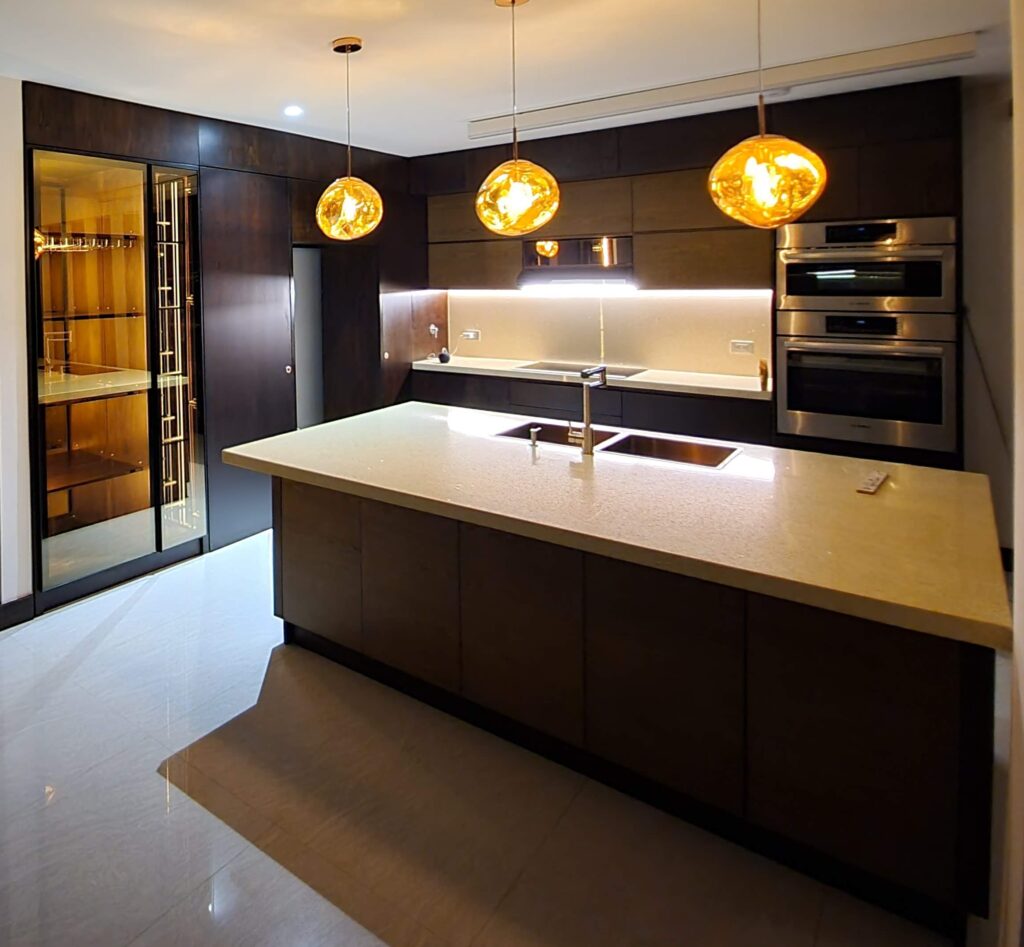 Luxury modern kitchen with custom solid walnut cabinetry and a minimalist island by Alterra Craft in Tucson
