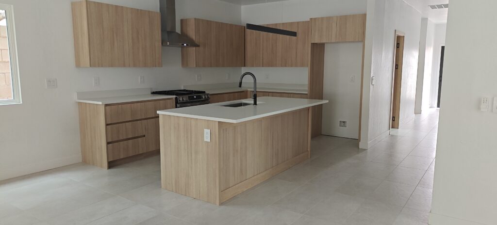 Custom white oak kitchen cabinets and central island installation by Alterra Craft in Tucson
