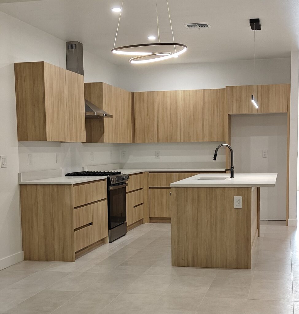 Custom white oak kitchen cabinets and minimalist island installation by Alterra Craft in Tucson