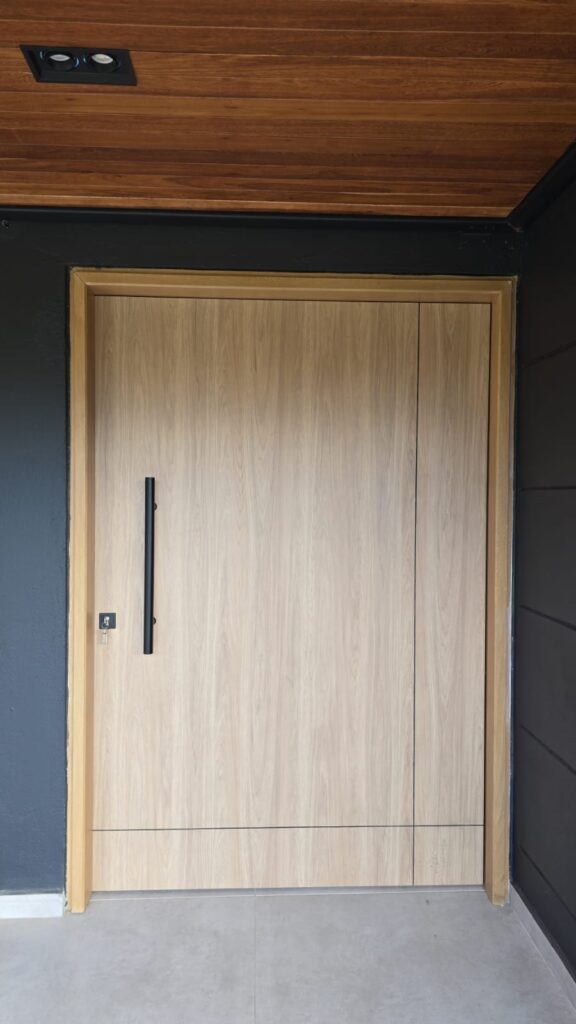 Modern double flush interior door in light oak with black steel frame, custom-built in Tucson, AZ